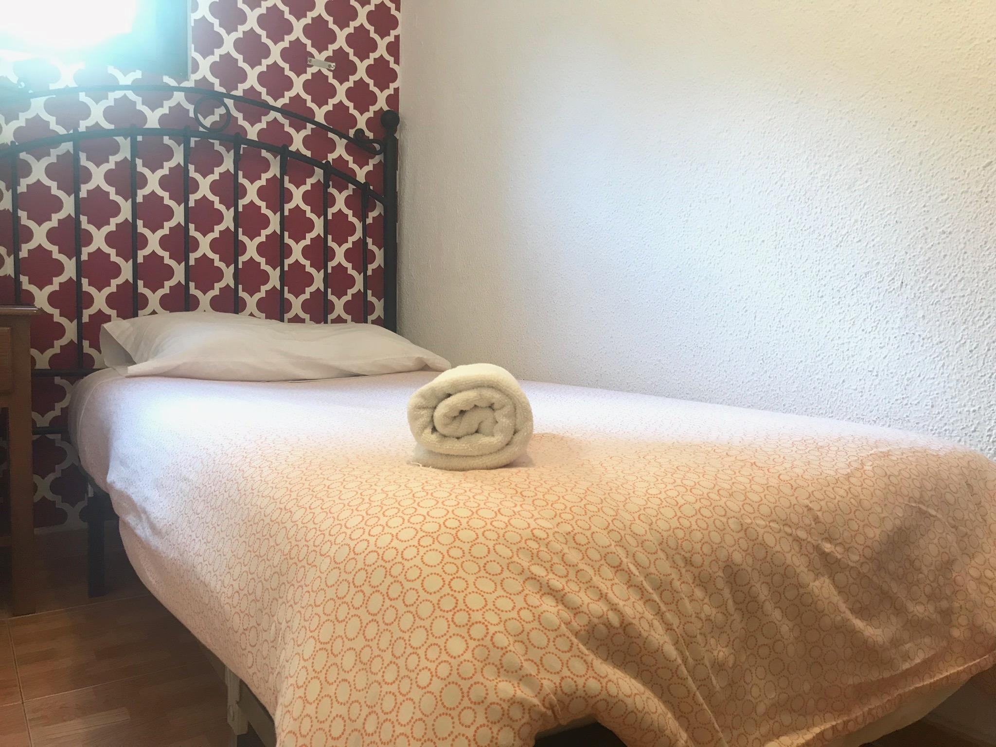 Hostal Los Perales Madrid Bagian luar foto A bed with a rolled towel
